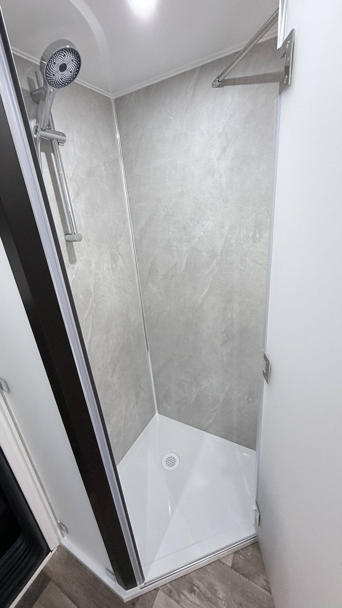 Ensuite shower with glass door and tiled walls