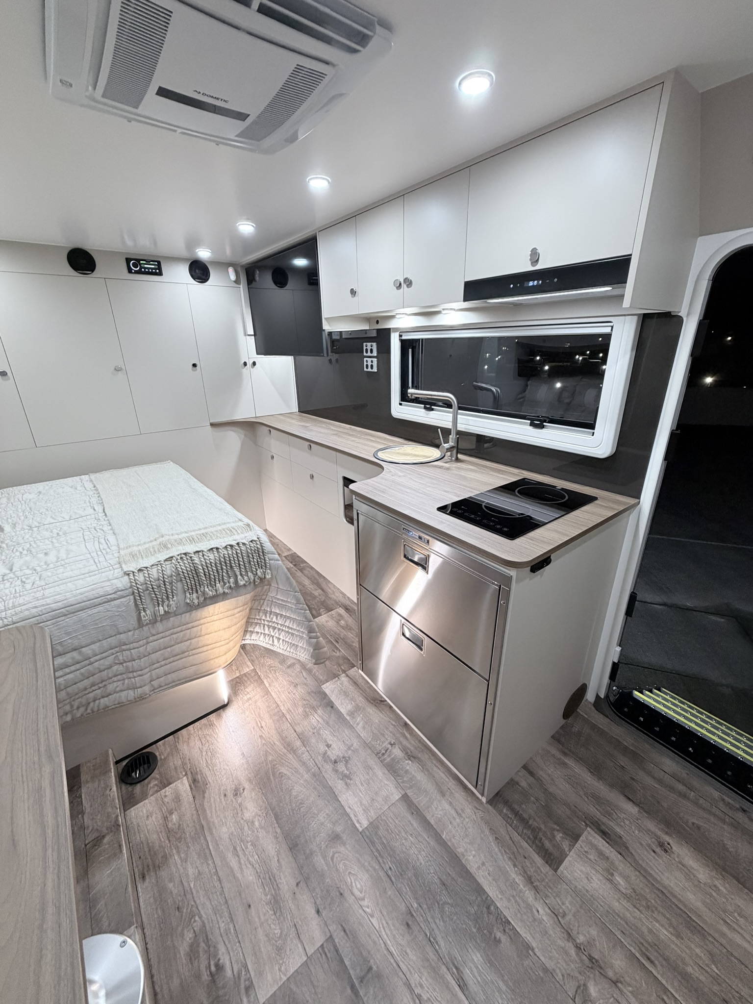 Kitchen with induction cooktop, Laminex benchtop and stainless steel drawer fridge