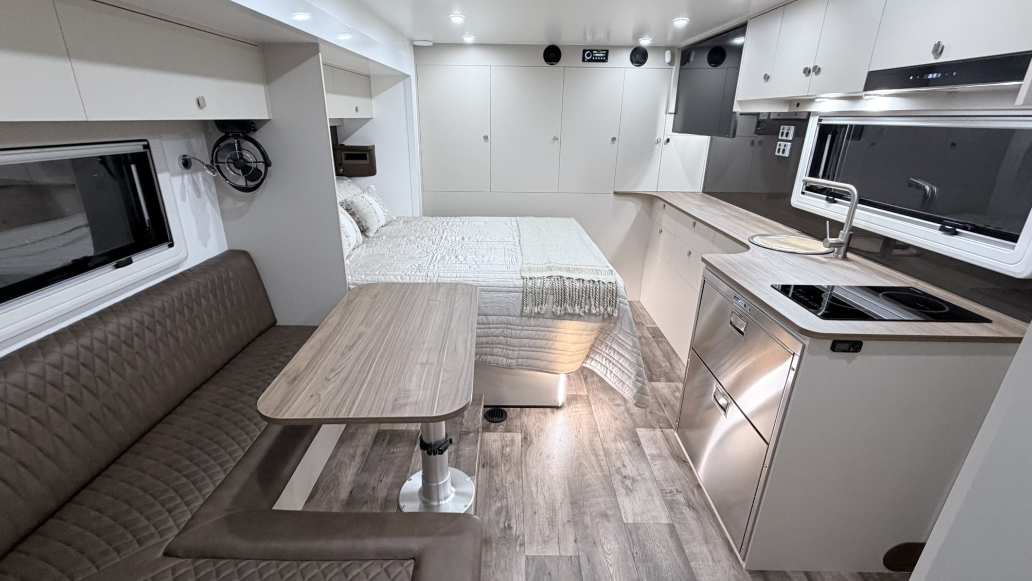 Wide view of the ibeX living area showing island bed, dinette and kitchen