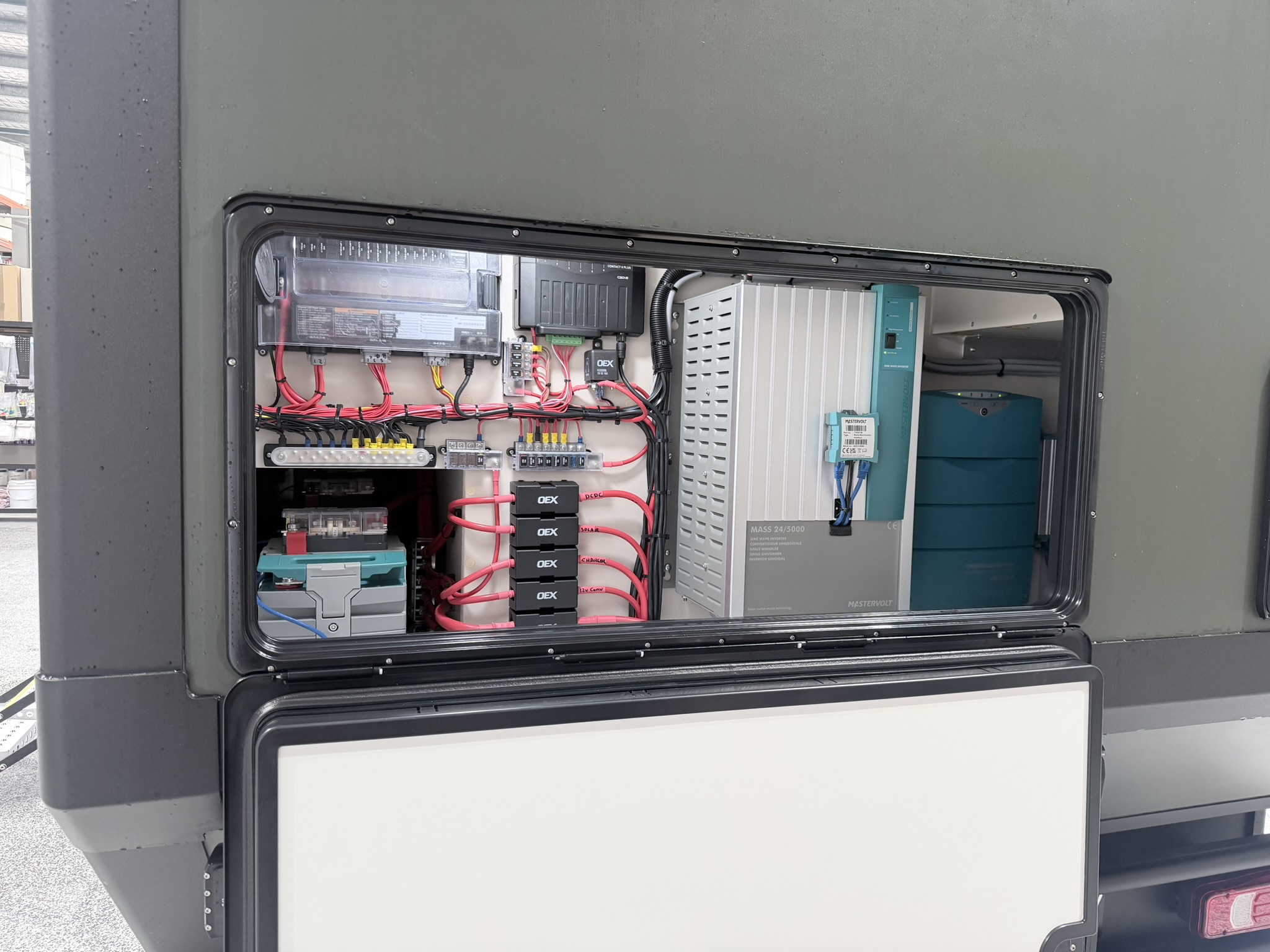 Electrical bay showing Mastervolt inverter/charger, fuse blocks and OEX relay modules